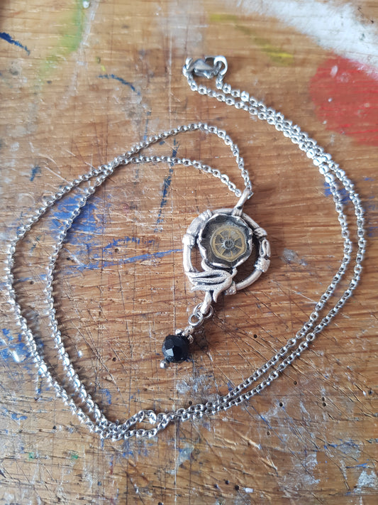 Pendant Featuring a Black Bead Drop And Watch Parts