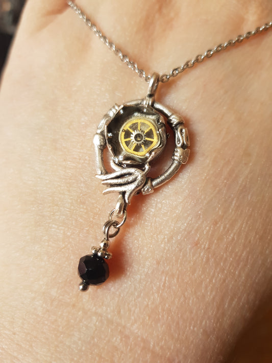 Pendant Featuring a Black Bead Drop And Watch Parts