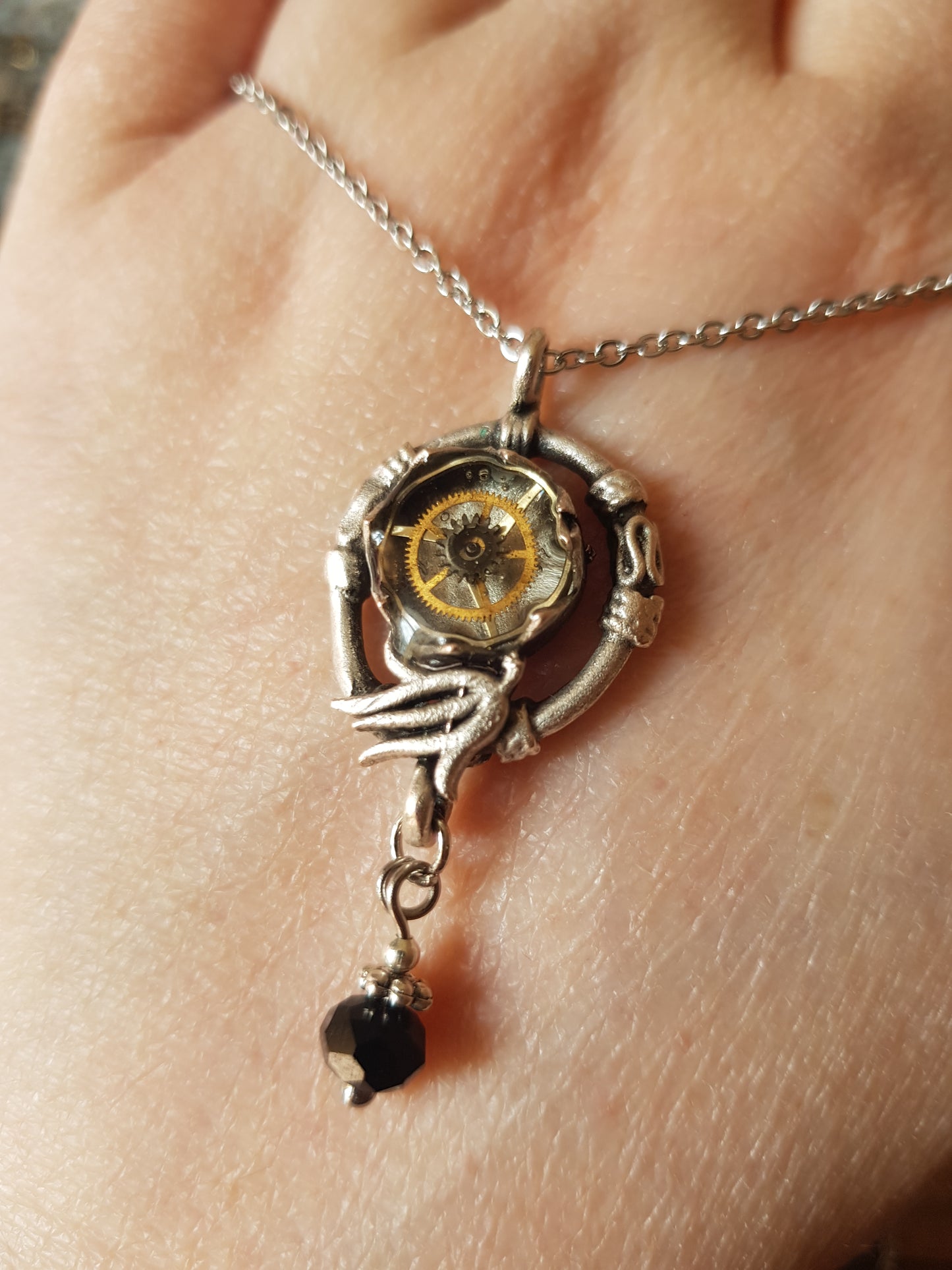 Pendant Featuring a Black Bead Drop And Watch Parts